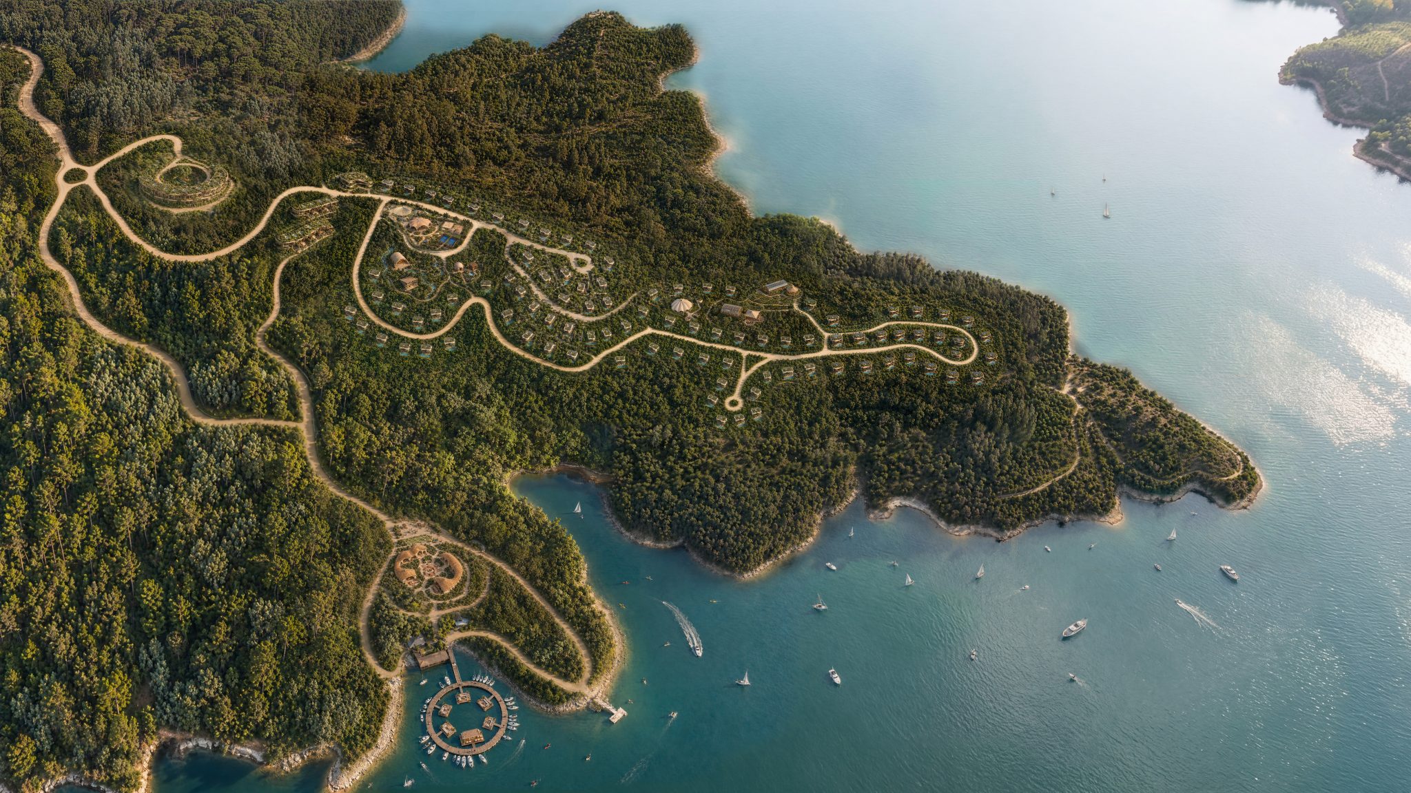 Aerial masterplan of Amara Nexus Village woven along a forested coastline in Portugal
